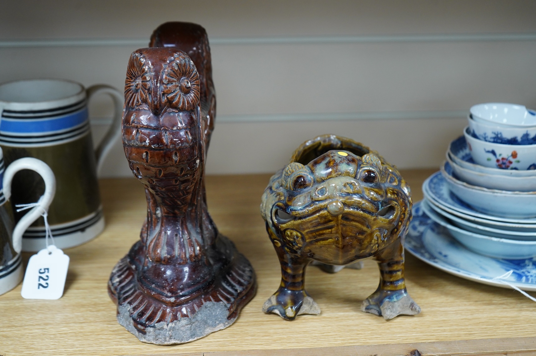 A late 19th century glazed pottery grotesque three legged toad spoon warmer in the manner of Dunmore or Burmantofts, and a Doulton owl andiron, largest 24cm high